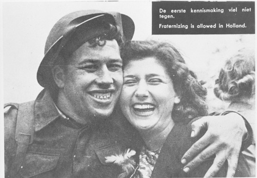 Canadees en een meisje. De Canadese soldaten maakten grote indruk: ze waren lang, gebruind, goed gevoed, afgetraind  en vrolijk. (Foto: 73475, NIOD)